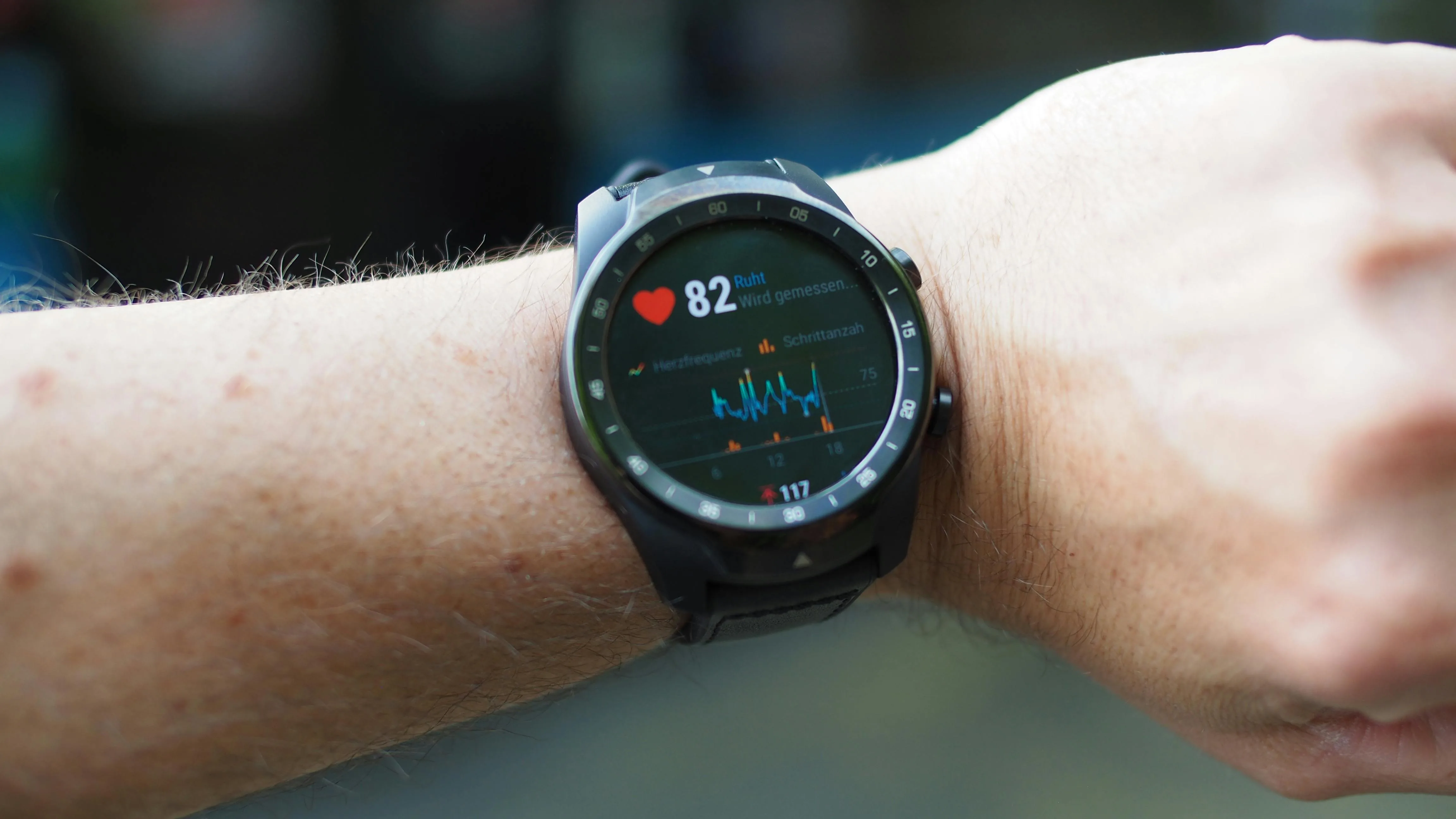 Person wearing a heart rate monitor smartwatch showing activity graph