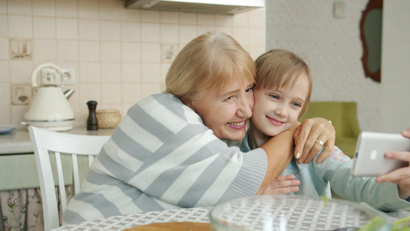 Grandparent and grandchild enjoying time together, bridging generations through shared technology