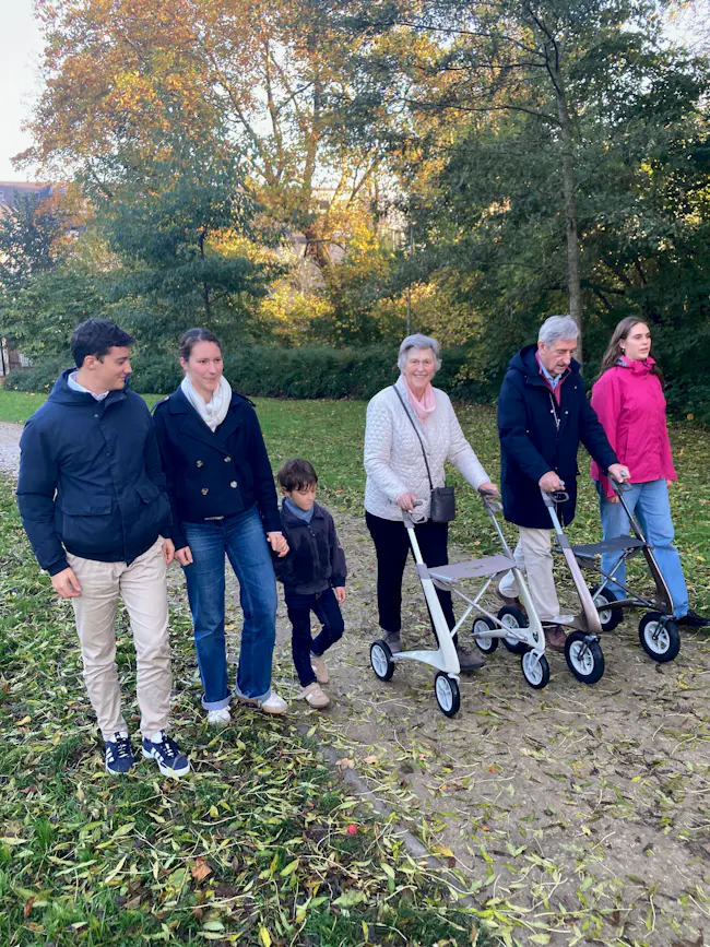 Active elderly person walking along a sunny park path, demonstrating how exercise protects the brain