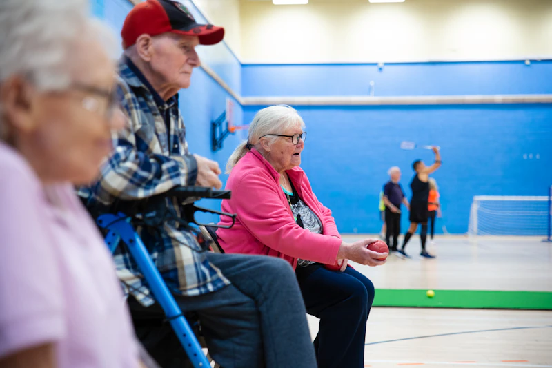 Active older adults including wheelchair users playing badminton at a community recreation centre