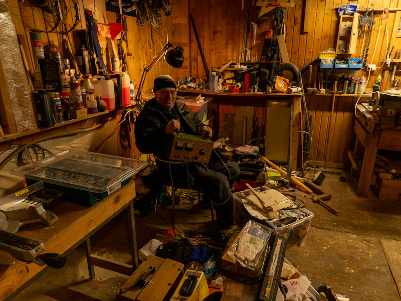 Older men working on woodworking projects together in a community shed workshop