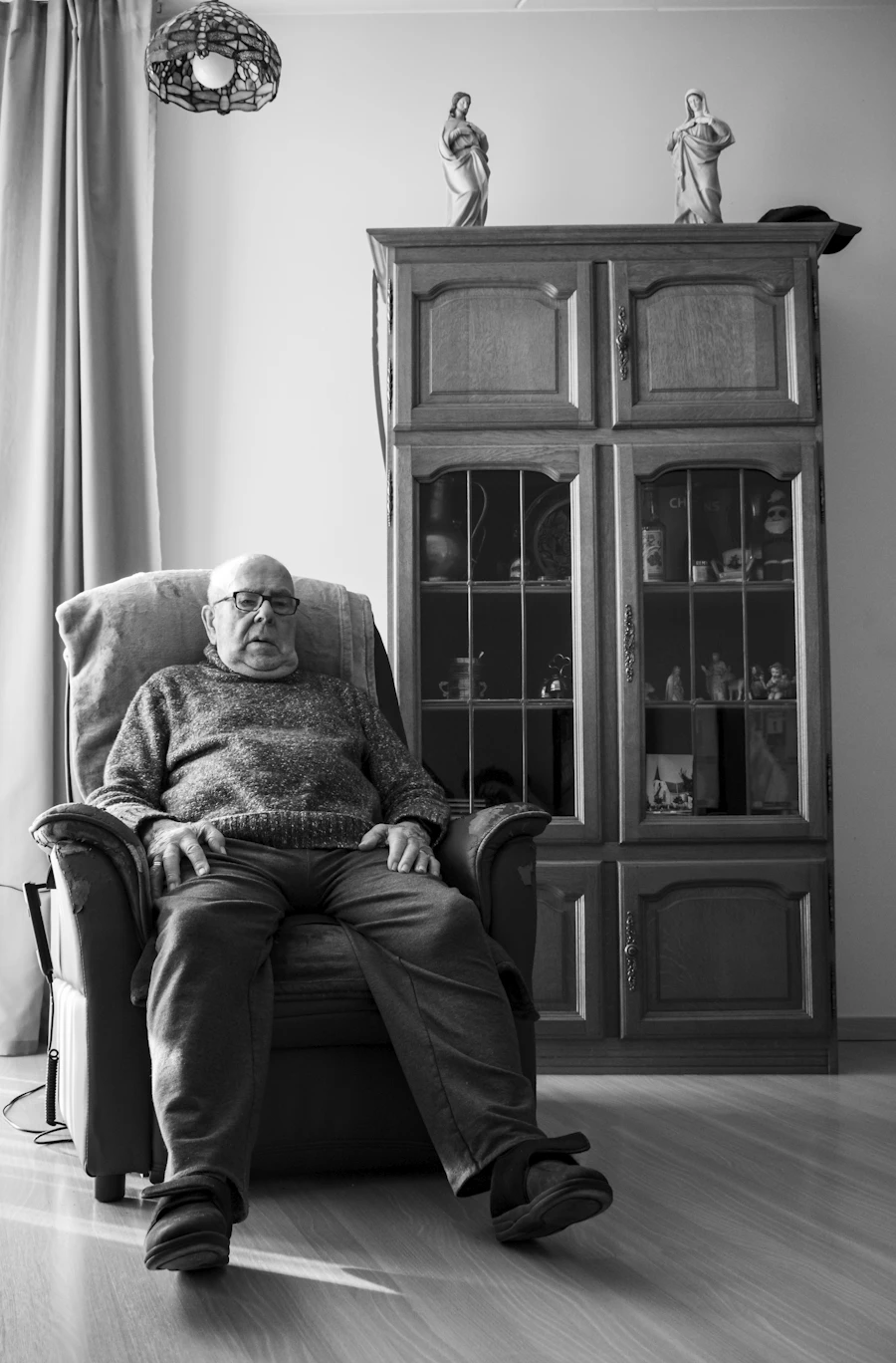 Elderly person resting peacefully with a relaxed expression in gentle natural light