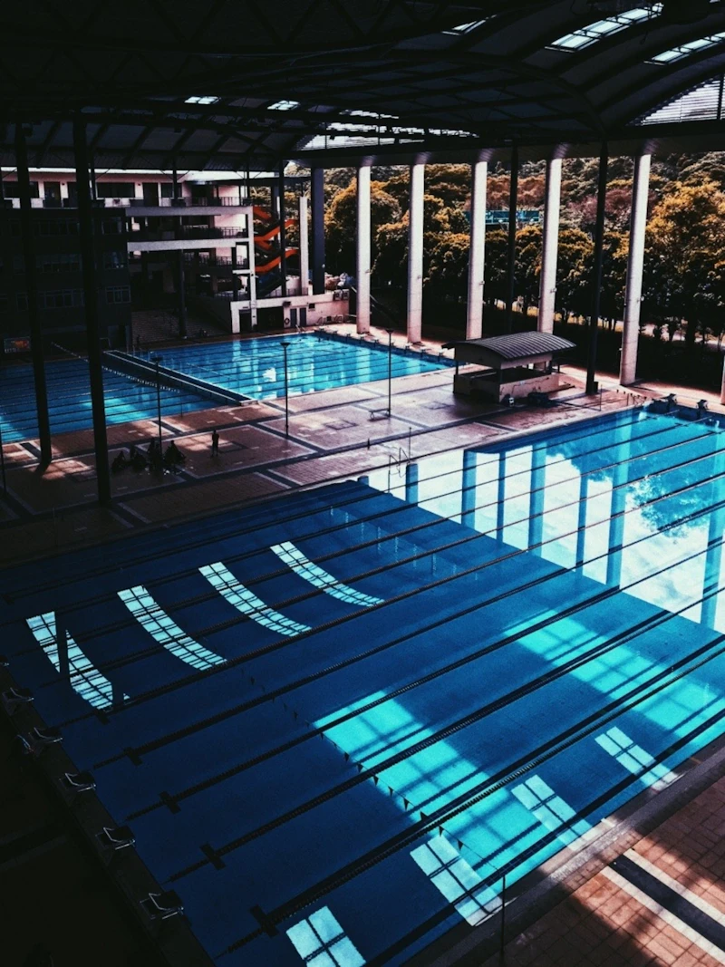 Older adults participating in water aerobics in a pool, enjoying low-impact hydrotherapy exercise