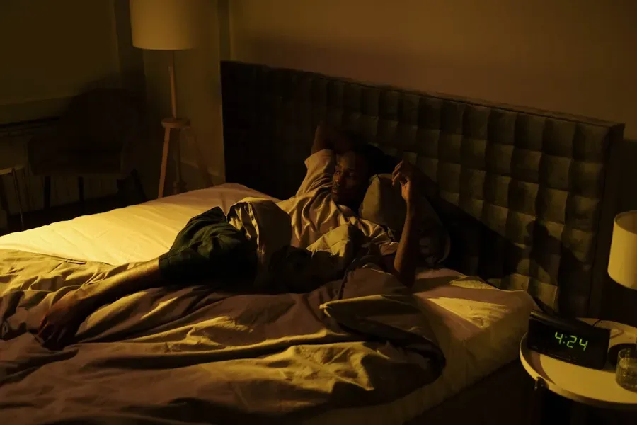 Senior woman sleeping peacefully in a warm, softly lit bedroom